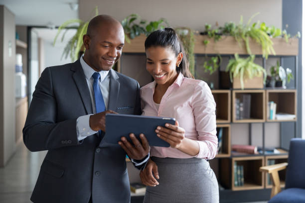istock Team of business people using a tablet computer while working at the office 1355515358