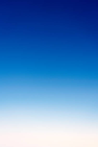 A graduated image from deep blue to near white - a genuine photograph of a clear, featureless summer sky.