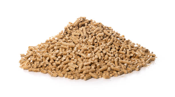 pile of wood pellets on white background stock photo