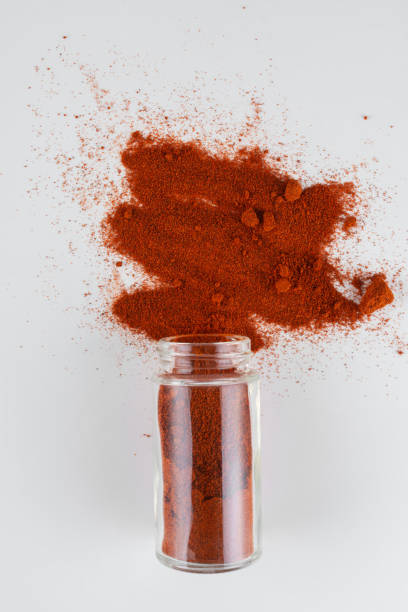 istock spices in a glass container are poured onto a white table 1355515772