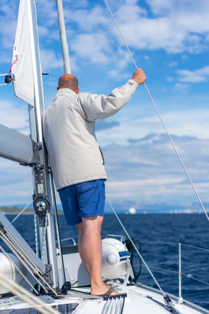 istock A man on a sailboat looking at mainland, Croatia 1355515874