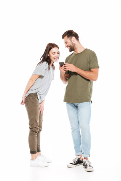 istock Woman looking in man's smartphone 1355516608