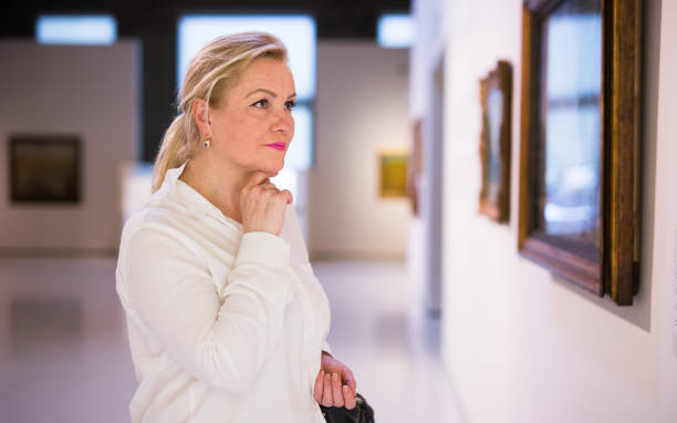 istock Closeup on mature female visiting museum 1355517058