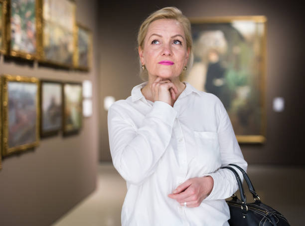 istock Closeup on mature female visiting museum 1355517063