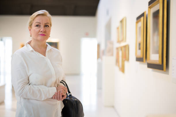 istock Closeup on mature female visiting museum 1355517084