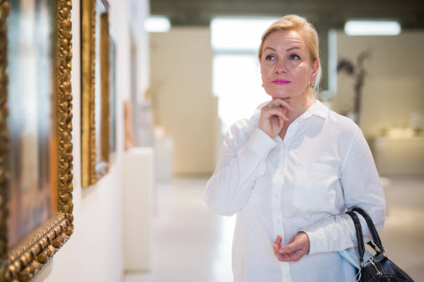 istock Closeup on mature female visiting museum 1355517100