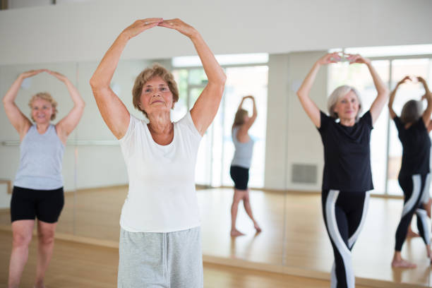 istock Mature women performing ballet dance in exercise room 1355517809