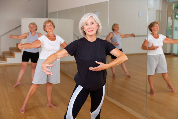 istock Mature active women perform ballet exercises in the studio 1355517825