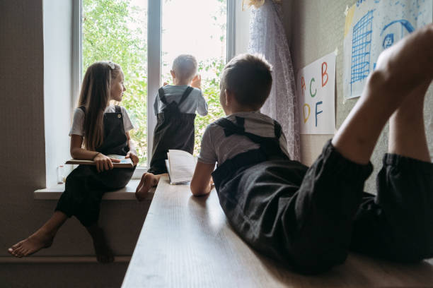 istock Back to school, Homeschooling, online study, home quarantine online learning education. Schoolchildren kids reading books at home during home schooling 1355517867