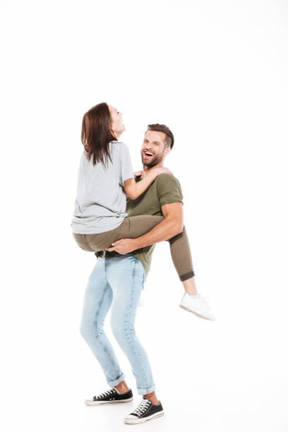 istock Laughing man holding on hands woman 1355518317