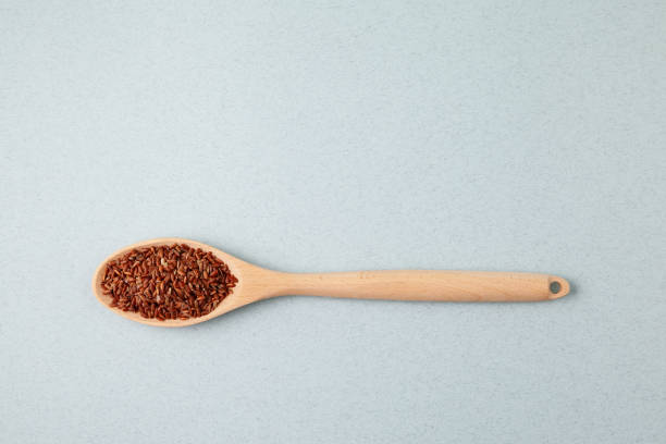 istock Brown GABA rice in long wooden spoon, top view. Selective focus, copy space 1355518732