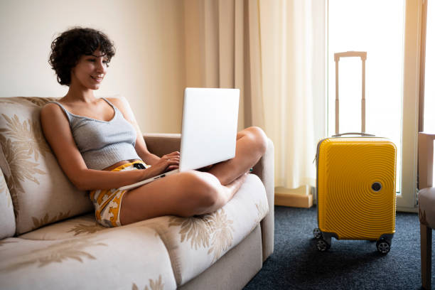 istock Serene female student e-learning from the hotel room 1355519670