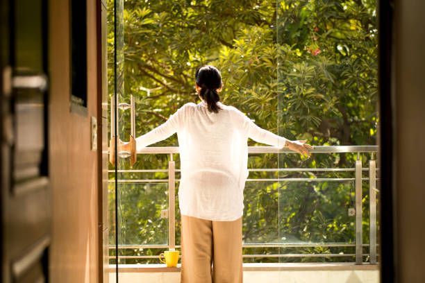 istock Woman admiring view from balcony 1355520325