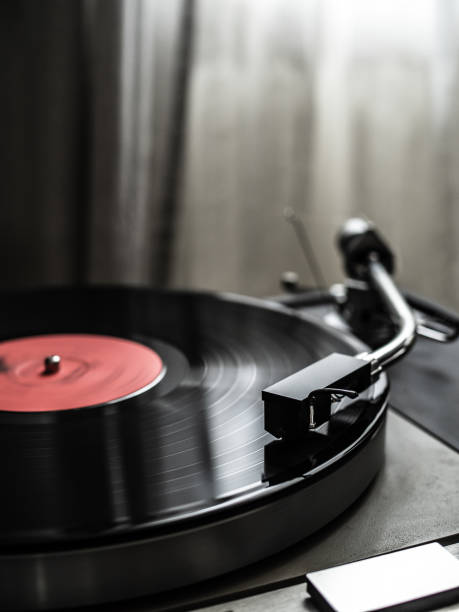 Turntable plays a vinyl record Turntable plays a vinyl record record analog audio stock pictures, royalty-free photos & images