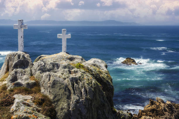 Crosses along the coast in memory of the brave fishermen who perished in the attempt to find the most beautiful and tastiest of barnacles, cape Roncudo, coast of death in Galicia, Spain stock photo