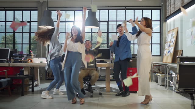 Slow Motion Shot Of Start-Up Business People Dancing In Office