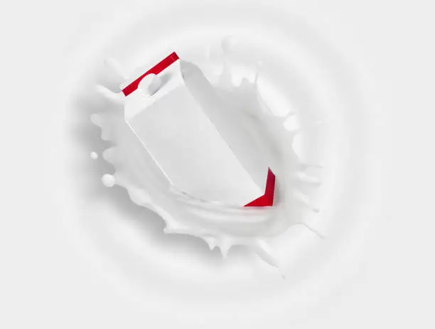 Photo of Milk carton falling into milk