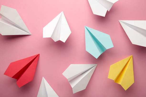 istock Paper plane on pink background, Business competition concept. 1355523823