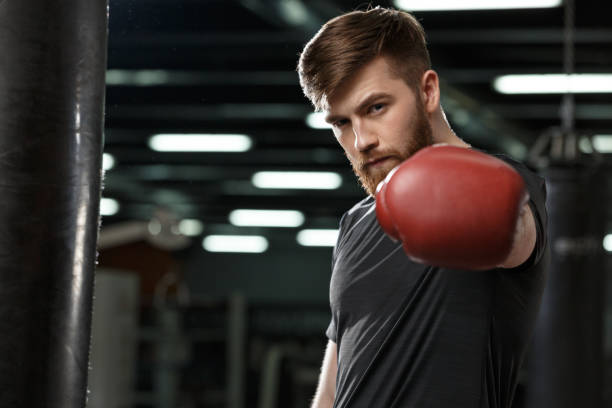 istock Serious handsome young strong sports man boxer 1355524932