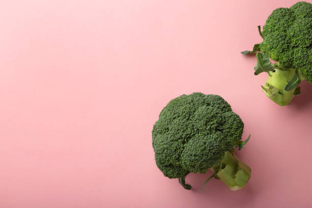 istock Broccoli cabbage on a pink background. Pattern of fresh broccoli cabbage. 1355525801