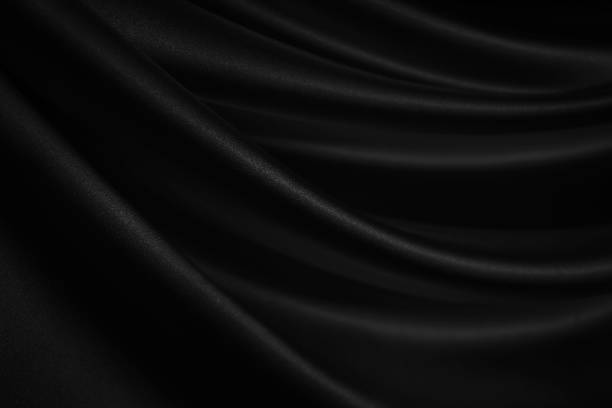 Black silk satin. Soft, wavy folds. Fabric surface. Luxurious black white background Black silk satin. Soft, wavy folds. Fabric surface. Luxurious black white background with copy space for design. Web banner. bed sheets stock pictures, royalty-free photos & images