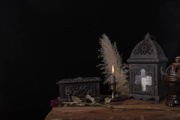 istock Dark still life with dried roses on wooden table. 1355526259