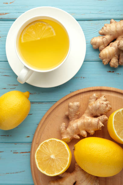 istock Ginger tea with lemon and honey on blue wooden background. Top view. 1355527232