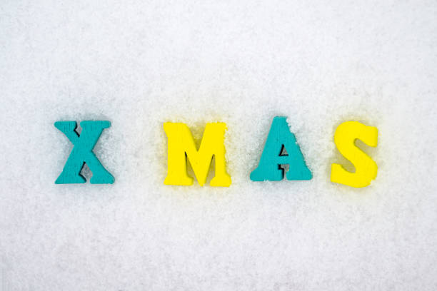 istock Inscription Xmas from colorfull letters on white snow surface. 1355527246