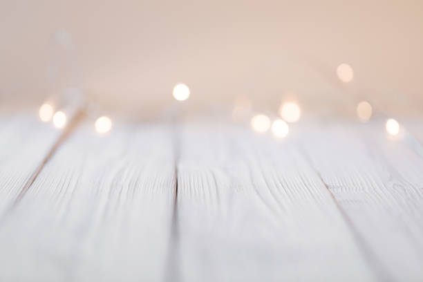 istock white abstract bokeh background behind wooden desk 1355527524