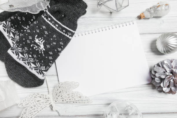 istock silver christmas decorations and notebook on white background. Flat lay, top view, copy space 1355527646