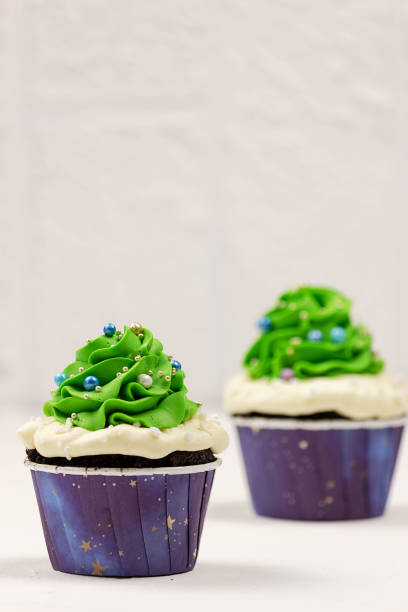 istock Christmas cupcakes on a white background. Selective focus, place for text. 1355528377