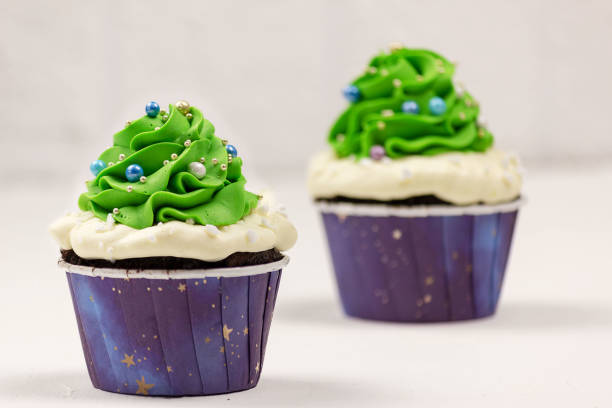 istock Christmas cupcakes on a white background. Selective focus, place for text. 1355528387