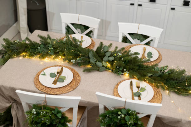 istock Christmas kitchen decor and table settings. Rustic cuisine at Christmas. Details of scandinavian cuisine in gold color. Kitchen island festive 1355529086