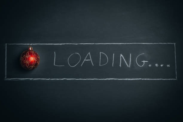 istock Christmas Loading Bar written in a blackboard with  a  Red Christmas Ball 1355529673