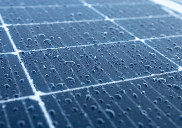 Solar photovoltaic modules with water drops stock photo