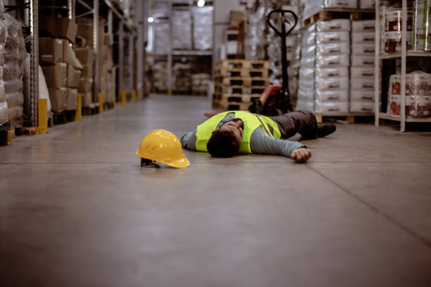istock Warehouse Worker Lying Unconscious on the Concrete 1355531070