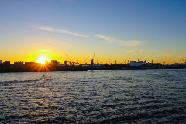 istock Sunset behind Harbor of Hamburg Germany 1355531105