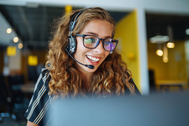 Young operator woman with headsets working in a call centre. stock photo