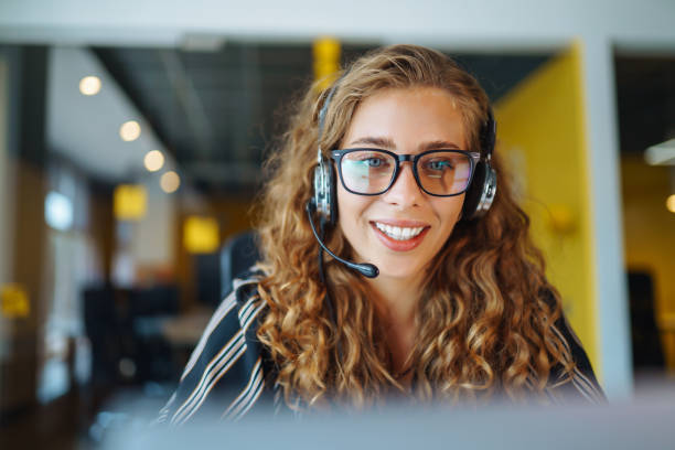 istock Young operator woman with headsets working in a call centre. 1355534342
