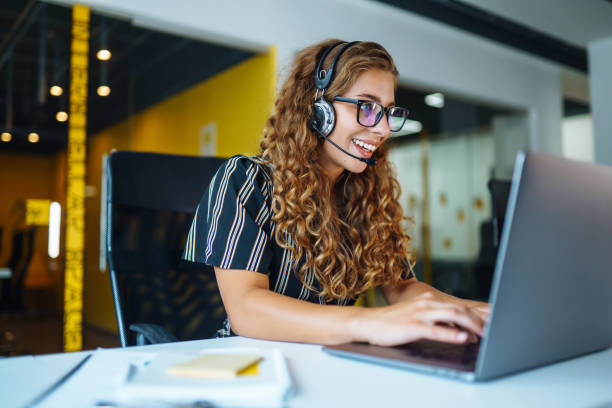 istock Young operator woman with headsets working in a call centre. 1355534345
