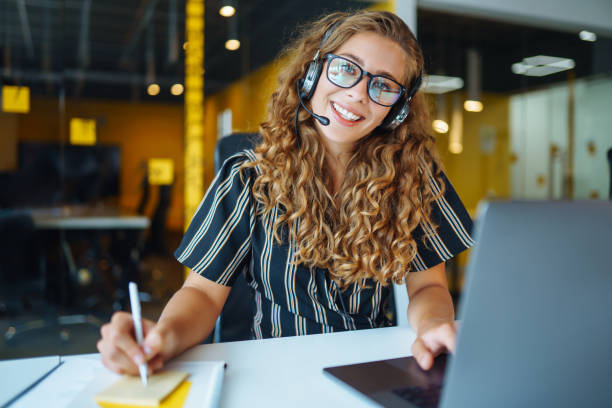istock Young operator woman with headsets working in a call centre. 1355534390