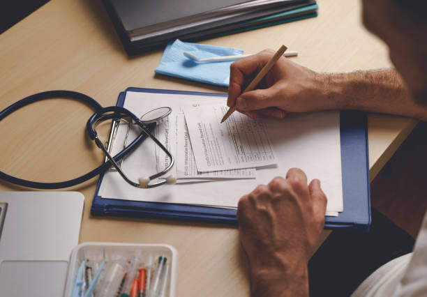 istock Vaccination record card. Vaccination form during the coronavirus epidemic on the doctor's table in the hospital. 1355536504