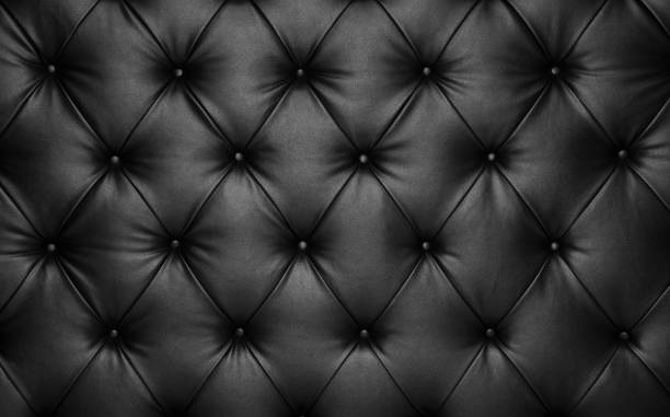 Black leather capitone background texture Close up background texture of black capitone genuine leather, retro Chesterfield style soft tufted furniture upholstery with deep diamond pattern and buttons upholstered furniture stock pictures, royalty-free photos & images