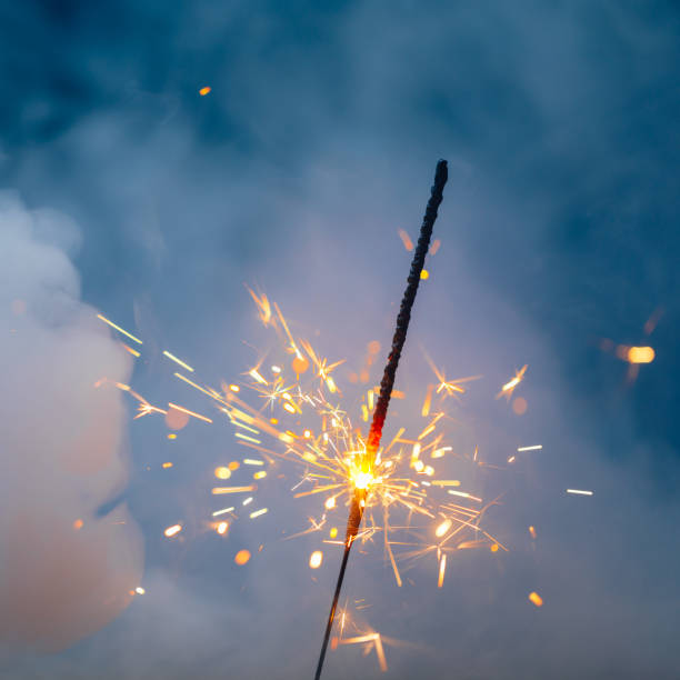 istock fire sparkler in dense smoke, abstract Christmas firework background 1355537643