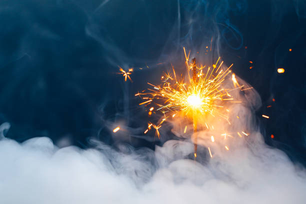 istock abstract Christmas sparkler firework background with smoke 1355537669