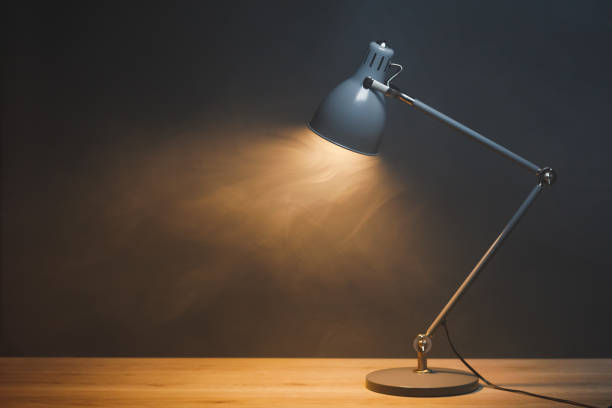 istock desk lamp in smoke, copy-space background 1355537697