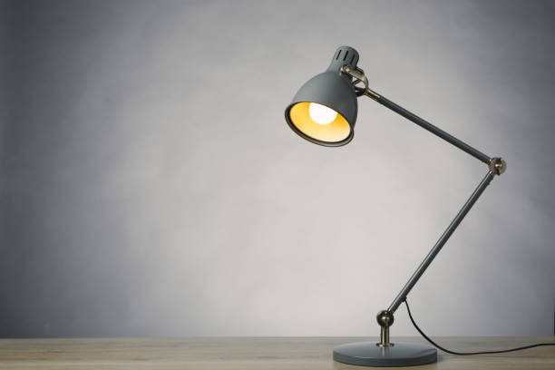istock desk lamp on the table, gray background with copy-space 1355537799