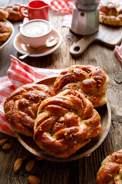 istock Homemade traditional cinnamon - cardamom sweet buns on a rustic table. 1355538279