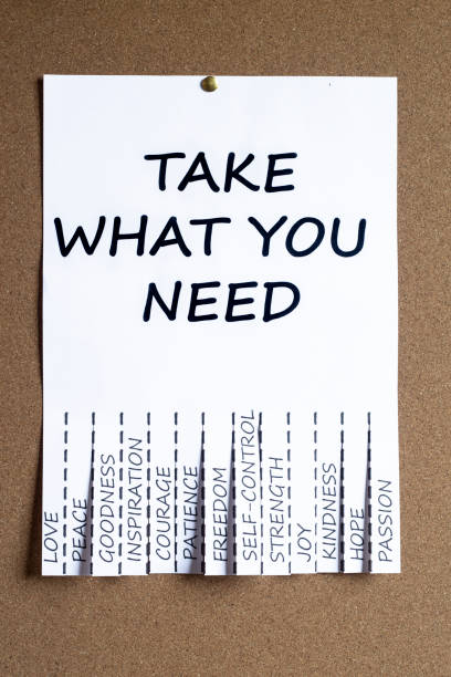 istock poster with various emotional needs ready to pick up, placed on an information cork board. vertical image 1355539187