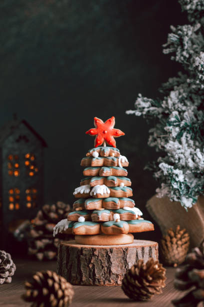 istock Gingerbread Christmas tree on dark table, Christmas card 1355540092